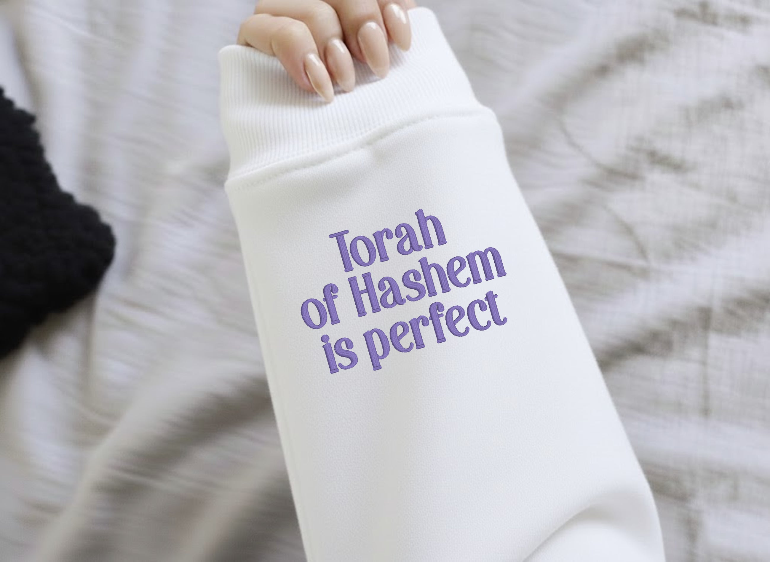 Sweatshirt with "Torah of Hashem is perfect" embroidered on a sleeve